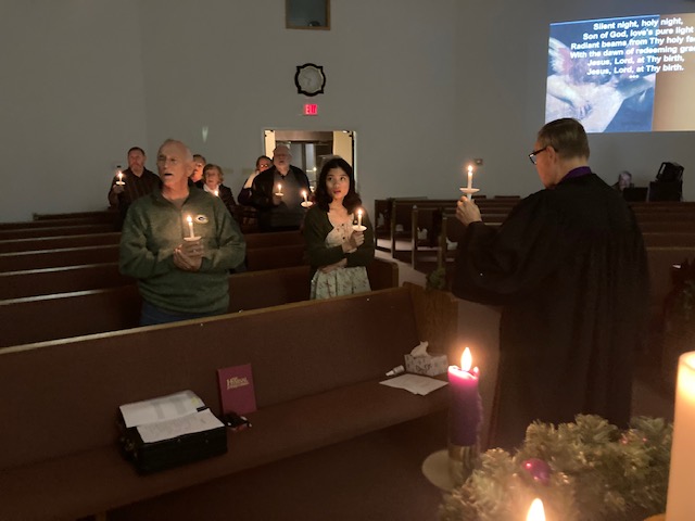 Church service with candles and community gathering